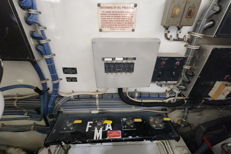Slide: The Image of Electrical panel and wiring inside a 1999 Hatteras 65 Convertible yacht engine room. - 87