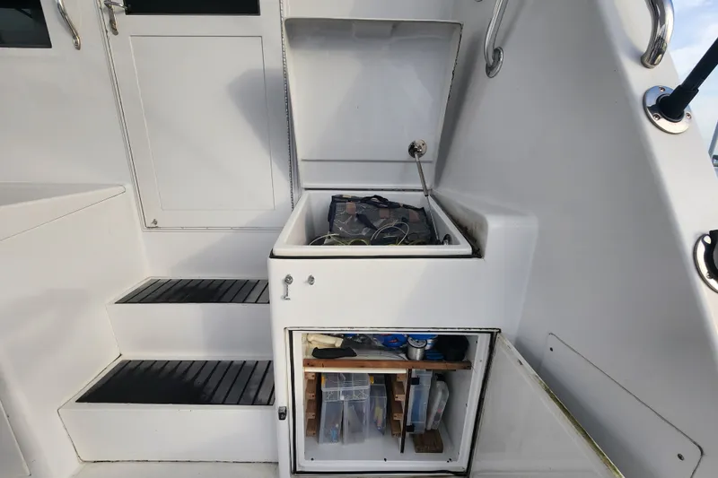 Slide: The Image of Storage compartments on a 1999 Hatteras 65 Convertible yacht, showcasing organized equipment. - 68