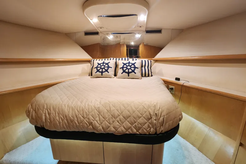 Slide: The Image of Luxurious cabin interior of 1999 Hatteras 65 Convertible yacht with nautical-themed decor. - 25