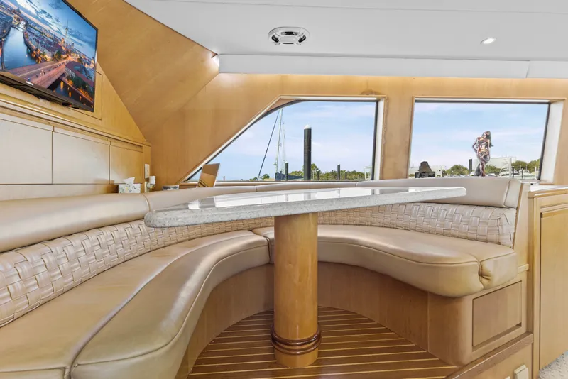 Slide: The Image of Luxurious interior of 1999 Hatteras 65 Convertible yacht with elegant seating and scenic windows. - 103