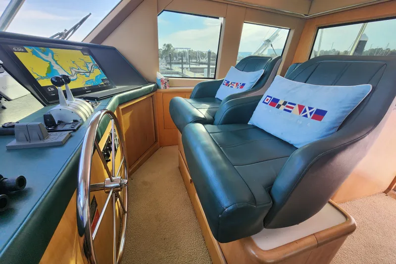 Slide: The Image of Interior of 1999 Hatteras 65 Convertible yacht with navigation system and plush seating. - 40