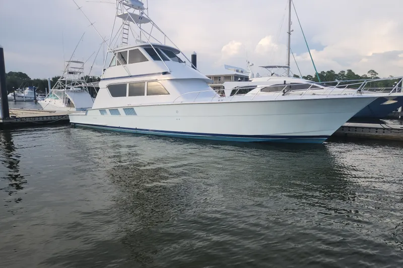 The Image of 1999 Hatteras 65 Convertible yacht docked at marina, side view. - 0