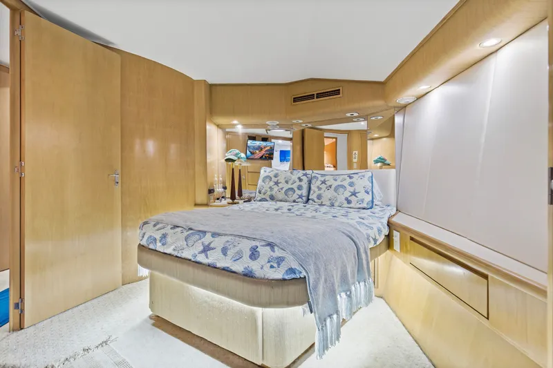 Slide: The Image of Luxurious bedroom interior of 1999 Hatteras 65 Convertible yacht with elegant bedding. - 99