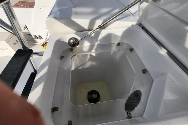 Slide: The Image of Hatteras 65 Convertible 1999 yacht deck detail with storage compartment and metal railing. - 47