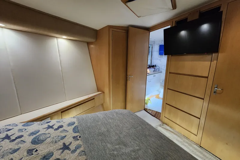 Slide: The Image of Luxurious cabin interior of 1999 Hatteras 65 Convertible yacht with modern amenities. - 22
