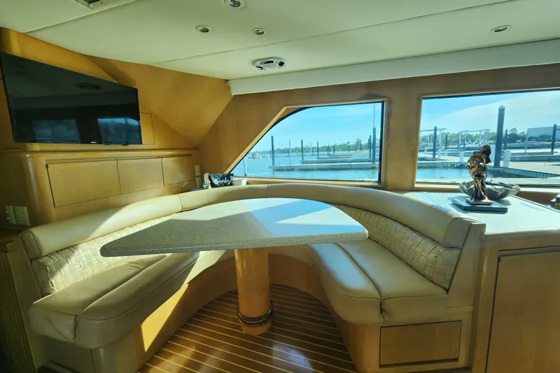 Slide: The Image of Luxurious interior of 1999 Hatteras 65 Convertible yacht with elegant seating and waterfront view. - 13