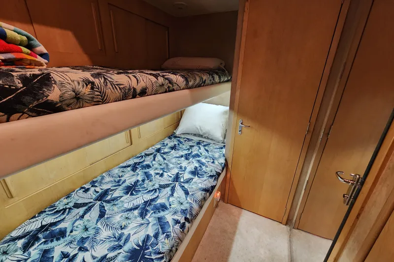 Slide: The Image of Bunk beds with floral bedding in 1999 Hatteras 65 Convertible yacht cabin. - 34