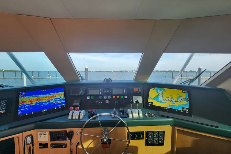 Slide: The Image of Cockpit view of 1999 Hatteras 65 Convertible yacht with navigation screens and steering wheel. - 38