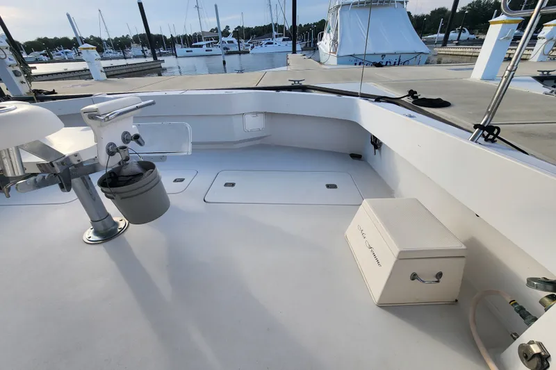 Slide: The Image of Cockpit of a 1999 Hatteras 65 Convertible yacht docked at a marina. - 61