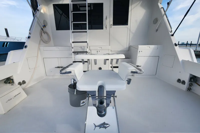 Slide: The Image of 1999 Hatteras 65 Convertible yacht cockpit with fishing chair and ladder. - 64