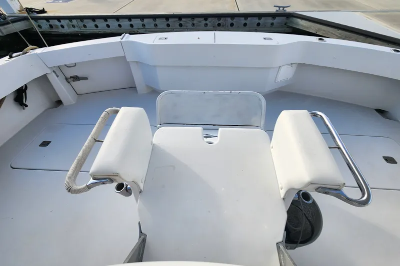 Slide: The Image of 1999 Hatteras 65 Convertible yacht deck with seating and railing. - 60
