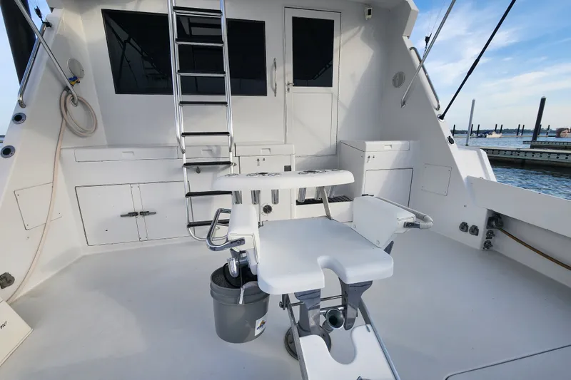 Slide: The Image of 1999 Hatteras 65 Convertible yacht cockpit with ladder and fishing chair. - 63