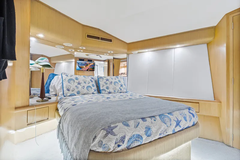 Slide: The Image of Luxurious bedroom interior of 1999 Hatteras 65 Convertible yacht with elegant bedding. - 98