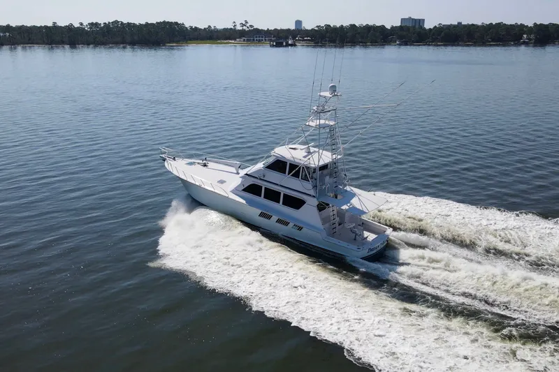 Slide: The Image of 1999 Hatteras 65 Convertible yacht cruising on calm waters. - 93