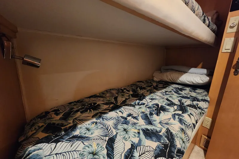 Slide: The Image of Cozy bunk bed with floral bedding in 1999 Hatteras 65 Convertible yacht cabin. - 30