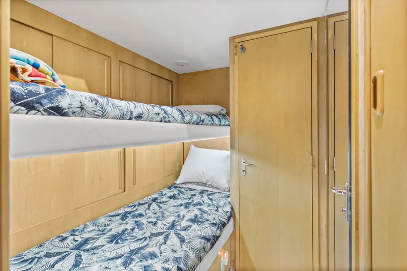 Slide: The Image of Bunk beds in 1999 Hatteras 65 Convertible yacht cabin with floral bedding. - 100