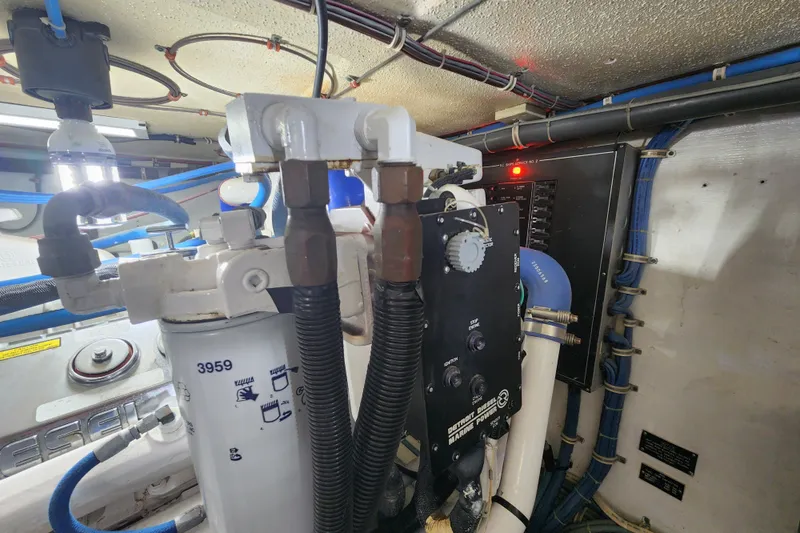 Slide: The Image of Engine room of 1999 Hatteras 65 Convertible with mechanical components and wiring. - 84