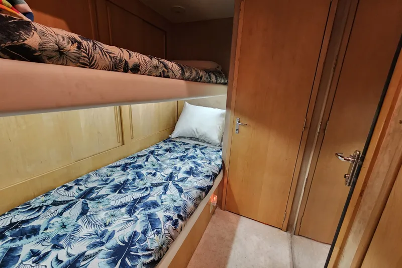Slide: The Image of Bunk beds with floral bedding in 1999 Hatteras 65 Convertible yacht cabin. - 33