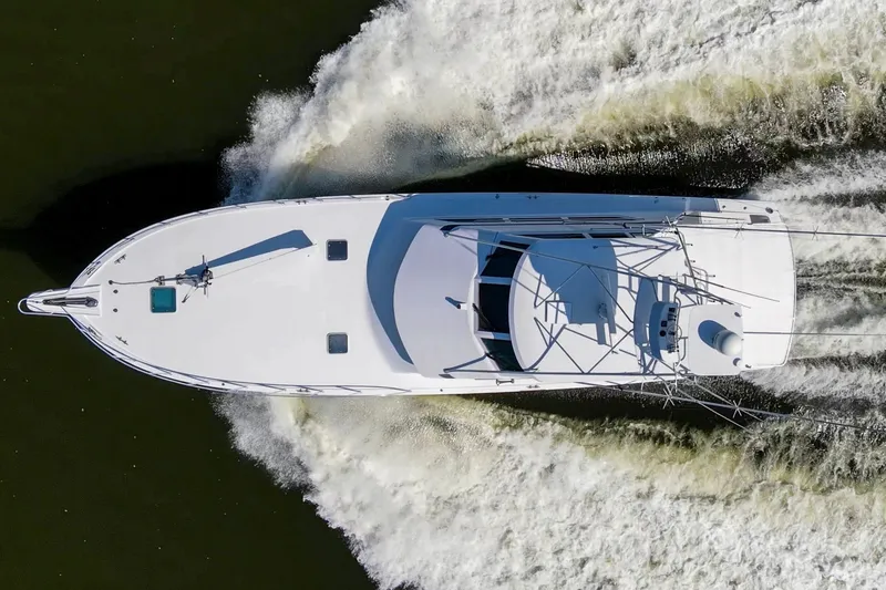 Slide: The Image of Aerial view of 1999 Hatteras 65 Convertible yacht cruising on water. - 94