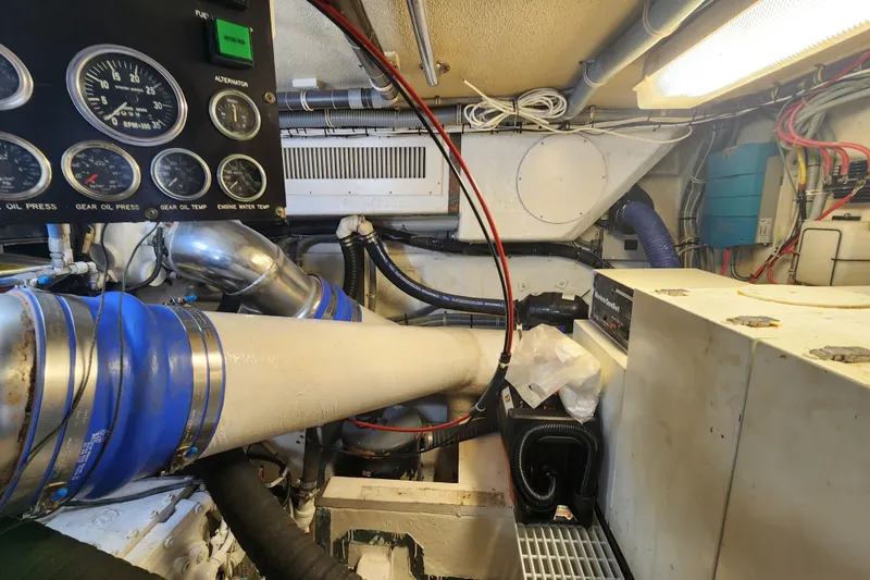 Slide: The Image of Engine room of a 1999 Hatteras 65 Convertible yacht with gauges and pipes. - 78