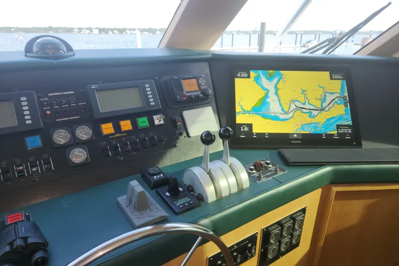 Slide: The Image of Cockpit of 1999 Hatteras 65 Convertible yacht with navigation and control systems. - 44