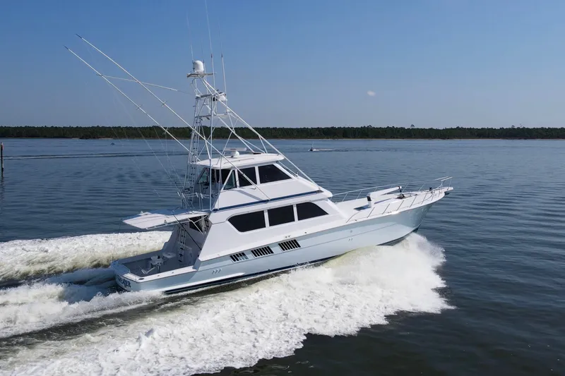 Slide: The Image of 1999 Hatteras 65 Convertible yacht cruising on calm waters. - 96