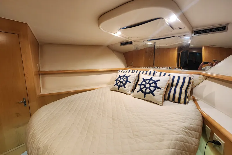Slide: The Image of Luxurious cabin interior of 1999 Hatteras 65 Convertible yacht with nautical-themed pillows. - 23