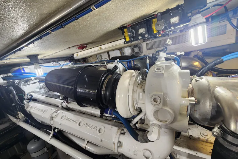 Slide: The Image of Engine room of 1999 Hatteras 65 Convertible yacht, showcasing diesel engine components. - 81