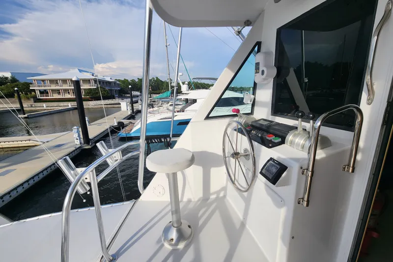 Slide: The Image of 1999 Hatteras 65 Convertible yacht helm with marina view. - 49
