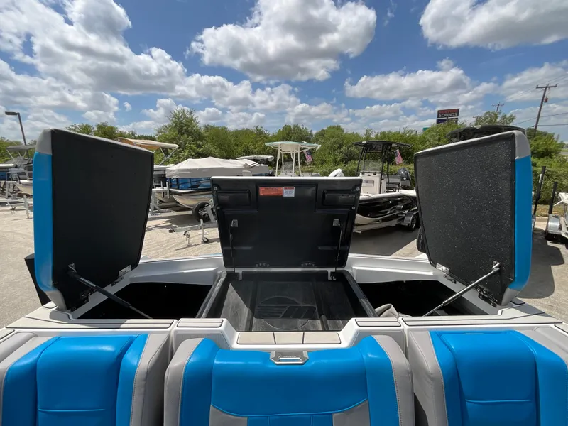 Slide: The Image of The image shows the open rear of a 2022 Malibu 23LVS boat with blue seats. - 13
