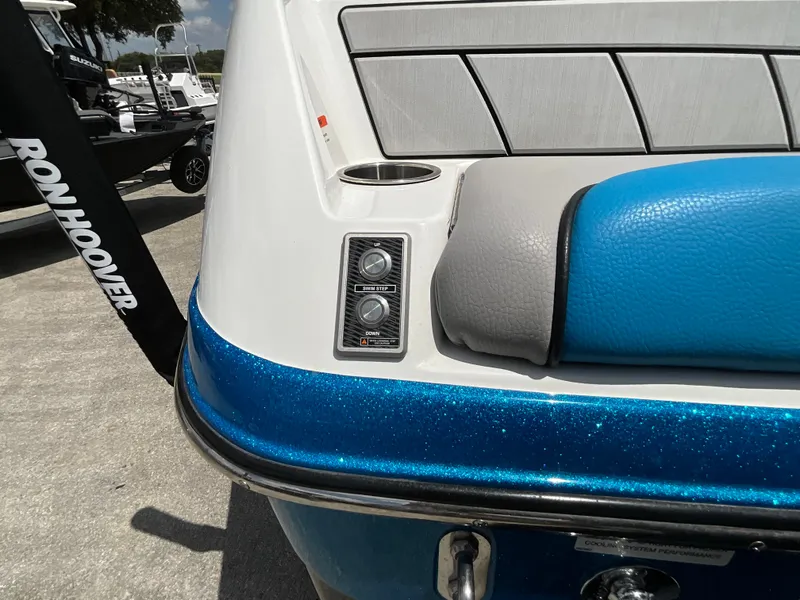 Slide: The Image of The image shows the rear of a 2022 Malibu 23LVS boat with blue metallic paint. - 34