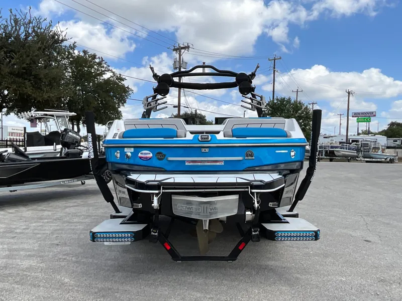 Slide: The Image of A blue 2022 Malibu 23LVS is parked on a lot. The sky is partly cloudy. - 4