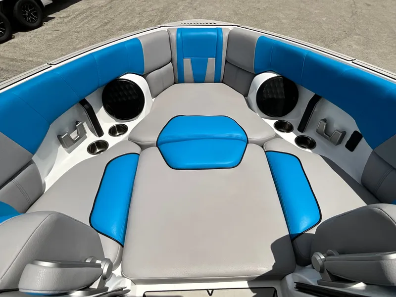 Slide: The Image of The image shows the bow area of a 2022 Malibu 23LVS boat with blue and gray upholstery. - 29
