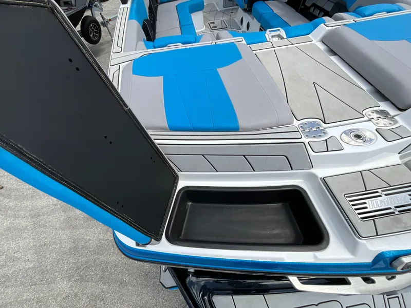 Slide: The Image of The image shows the deck of a 2022 Malibu 23LVS boat with blue and gray upholstery. - 7