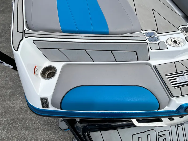 Slide: The Image of The image shows the stern of a 2022 Malibu 23LVS boat with blue and gray upholstery. - 6