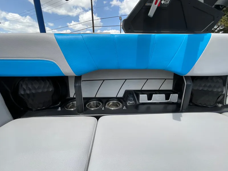 Slide: The Image of The image shows the interior of a 2022 Malibu 23LVS boat with blue and gray upholstery. - 20