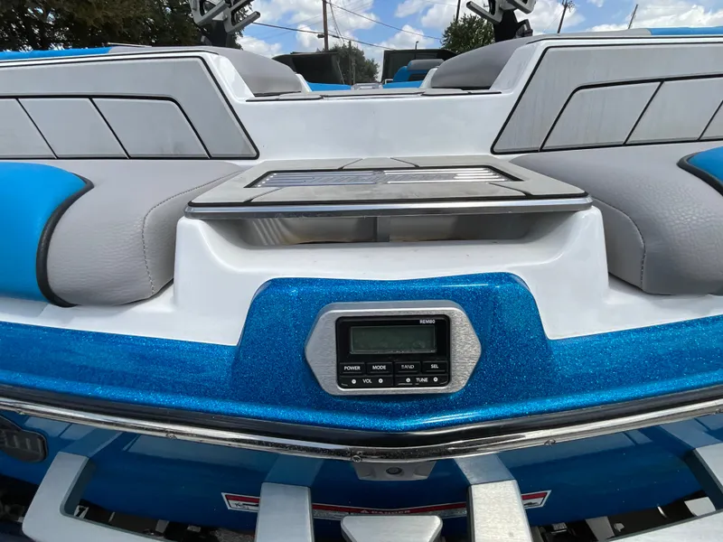 Slide: The Image of The image shows the stern of a 2022 Malibu 23LVS boat with blue trim and a control panel. - 10