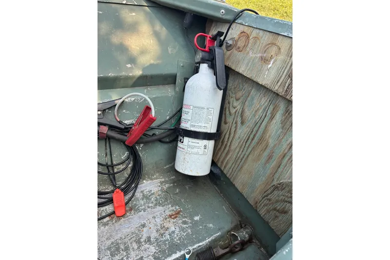 Slide: The Image of Fire extinguisher and cables inside a 1999 Jon Boat 1436. - 13