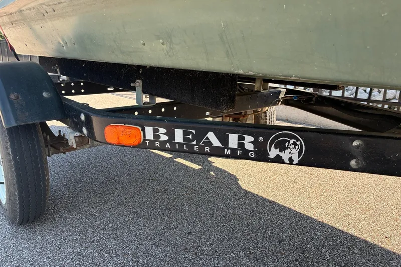Slide: The Image of Trailer for 1999 Jon Boat 1436 by Bear Trailer MFG on pavement. - 7