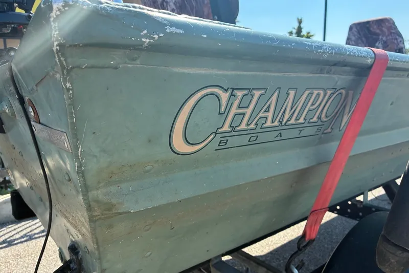 Slide: The Image of 1999 Jon Boat 1436 with Champion Boats logo, secured with a red strap. - 2