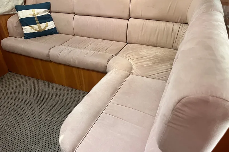 Slide: The Image of Luxurious beige seating on 2003 Pachoud Yachts Power Cat with nautical-themed pillow. - 18