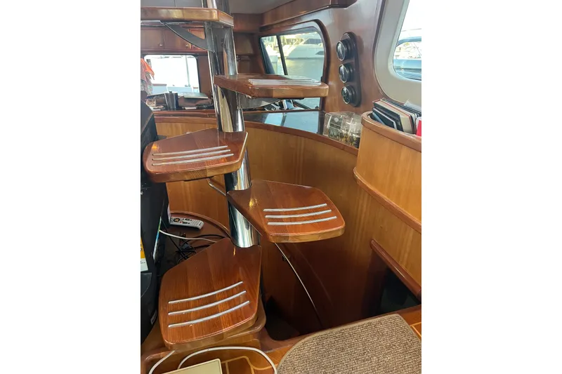 Slide: The Image of Interior of 2003 Pachoud Yachts Power Cat featuring wooden spiral staircase. - 22