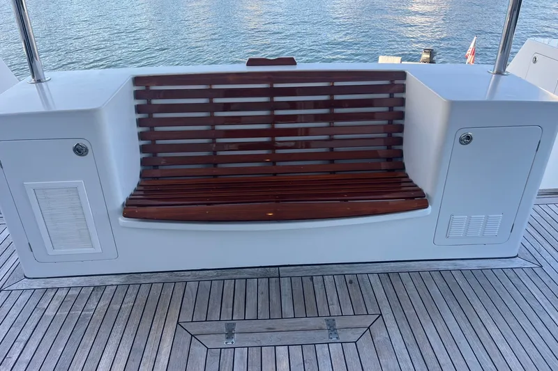 Slide: The Image of Wooden bench on 2003 Pachoud Yachts Power Cat, overlooking serene water. - 10