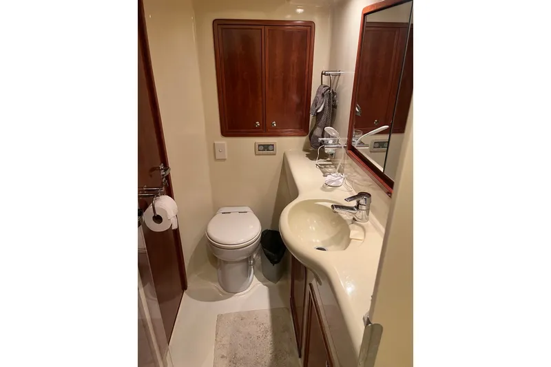 Slide: The Image of Luxurious bathroom in 2003 Pachoud Yachts Power Cat, featuring elegant wood cabinetry and modern fixtures. - 25
