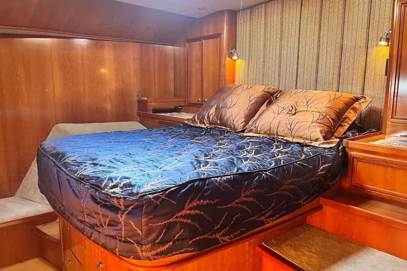 Slide: The Image of Luxurious bedroom interior of 2003 Pachoud Yachts Power Cat with elegant wood finish. - 28