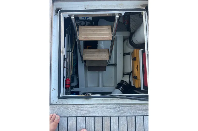 Slide: The Image of Engine room access hatch of 2003 Pachoud Yachts Power Cat with visible equipment and steps. - 28