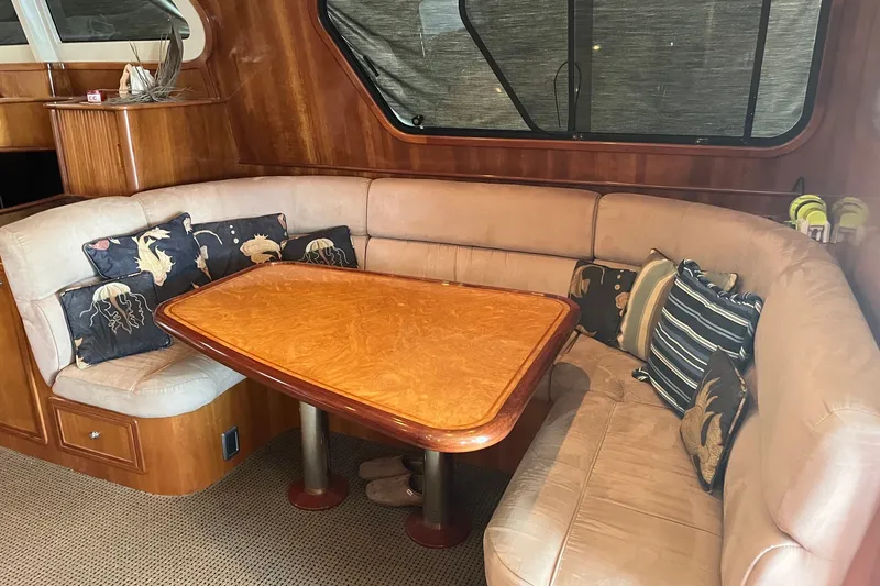 Slide: The Image of Luxurious 2003 Pachoud Yachts Power Cat interior with plush seating and elegant wooden table. - 16