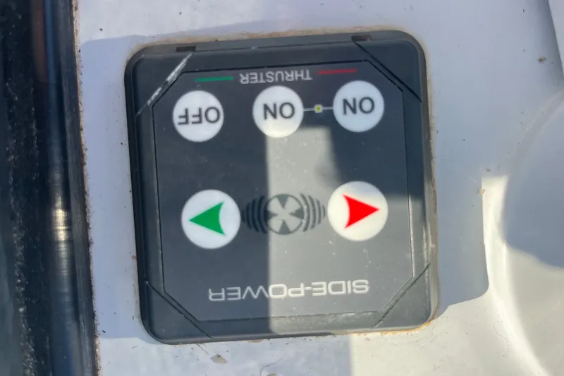 Slide: The Image of Control panel on a 2003 Pachoud Yachts Power Cat, featuring directional buttons. - 35