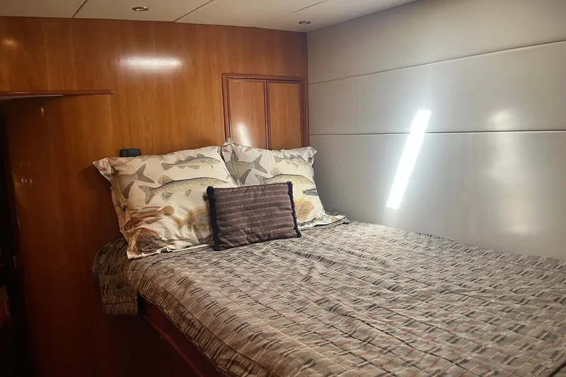Slide: The Image of Luxurious bedroom interior of 2003 Pachoud Yachts Power Cat with wooden accents and cozy bedding. - 24