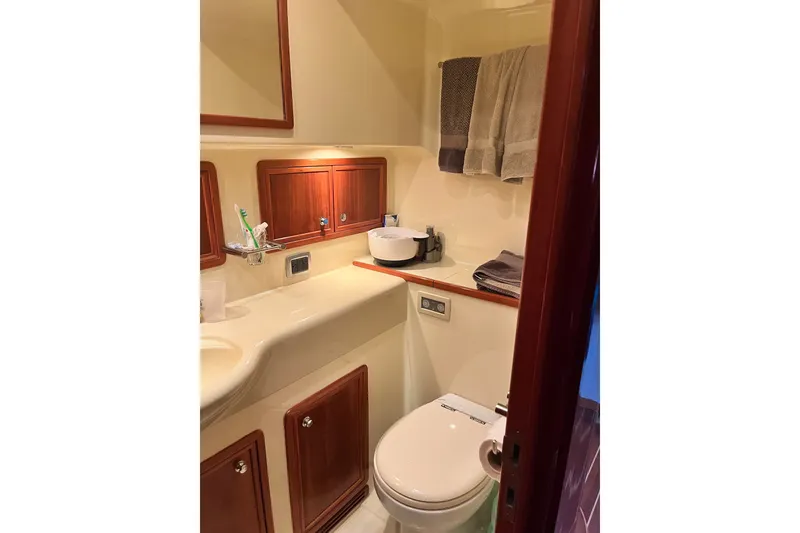 Slide: The Image of Luxurious bathroom in 2003 Pachoud Yachts Power Cat, featuring elegant wood cabinetry and modern fixtures. - 30